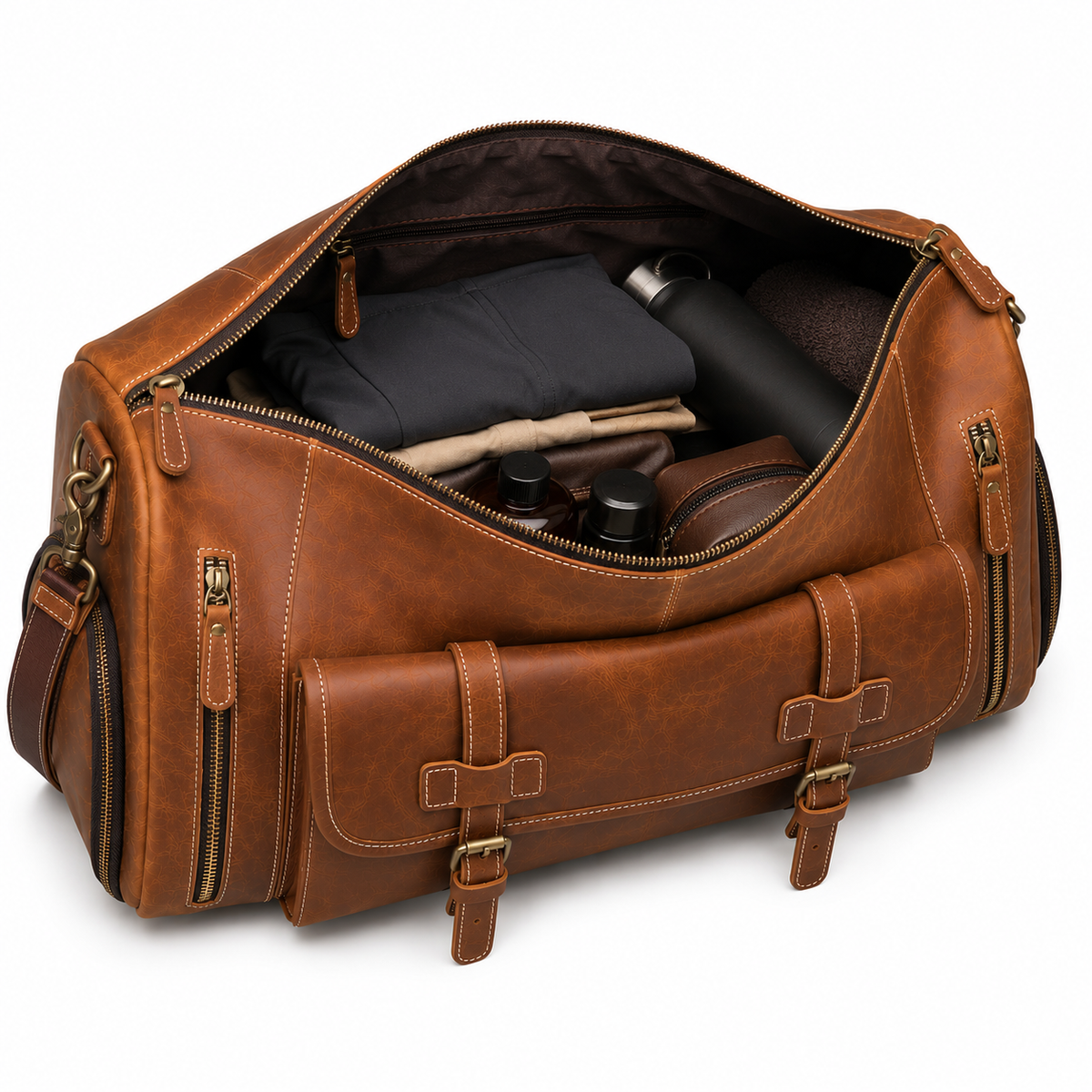 Compartiment principal ouvert du sac en cuir marron avec vêtements et accessoires de toilette rangés à l'intérieur