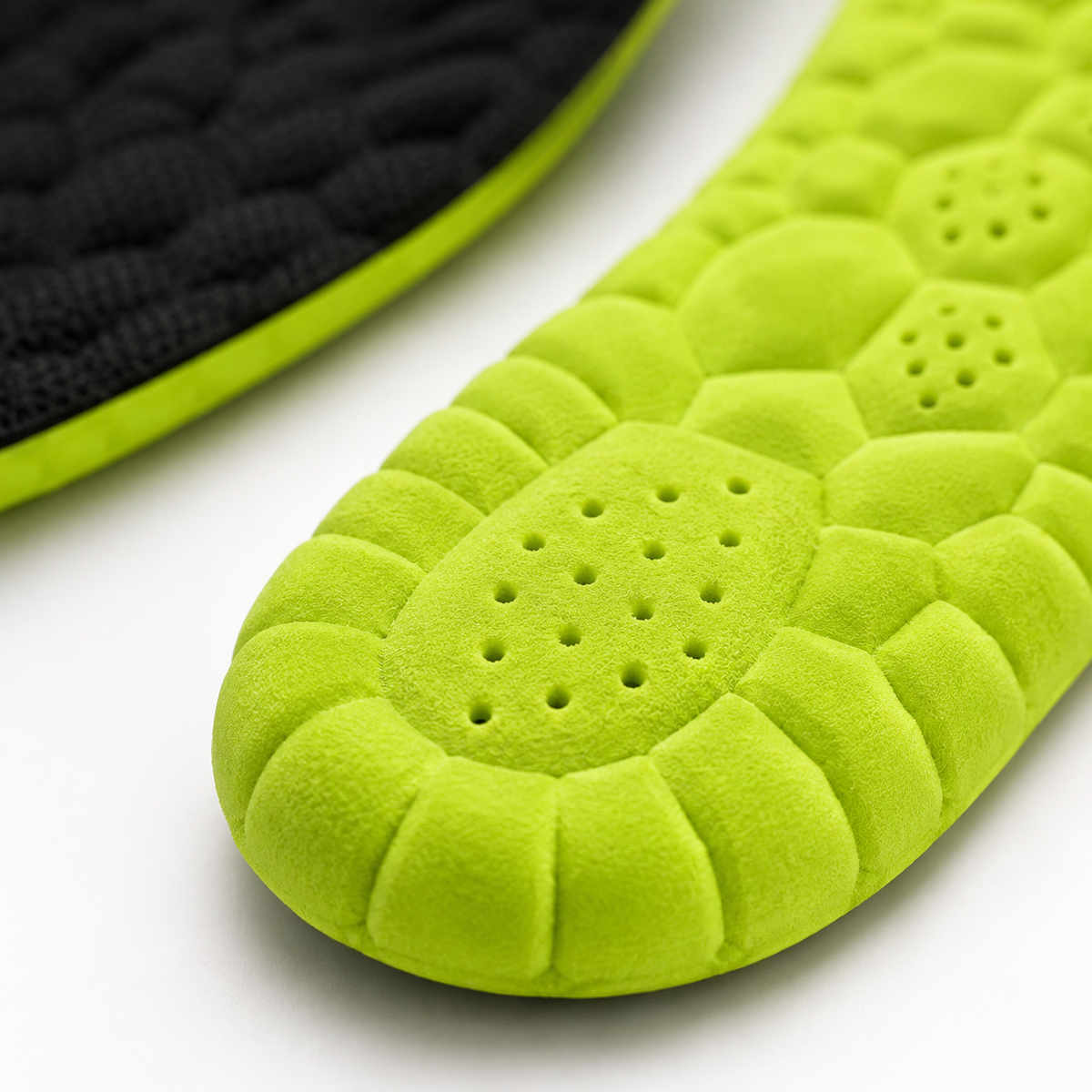 Gros plan sur la texture alvéolée verte de la semelle 4D en fibre de bambou